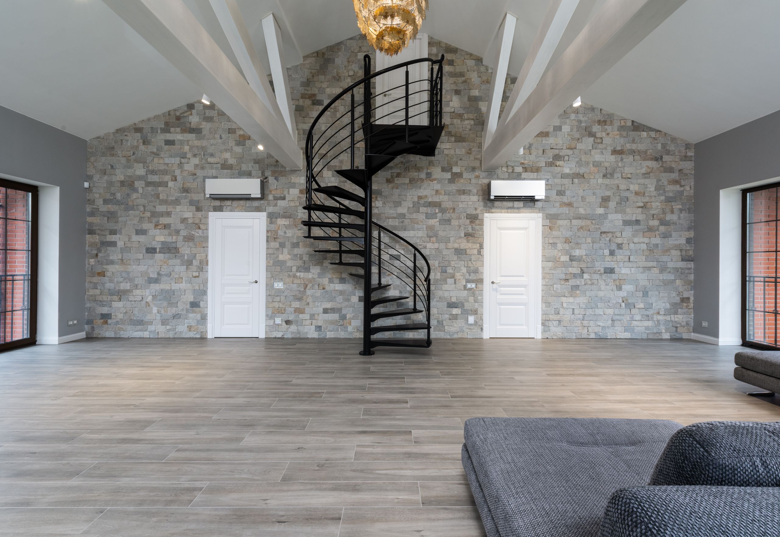 Interior of contemporary cozy apartment with large living room decorated with black metal steps